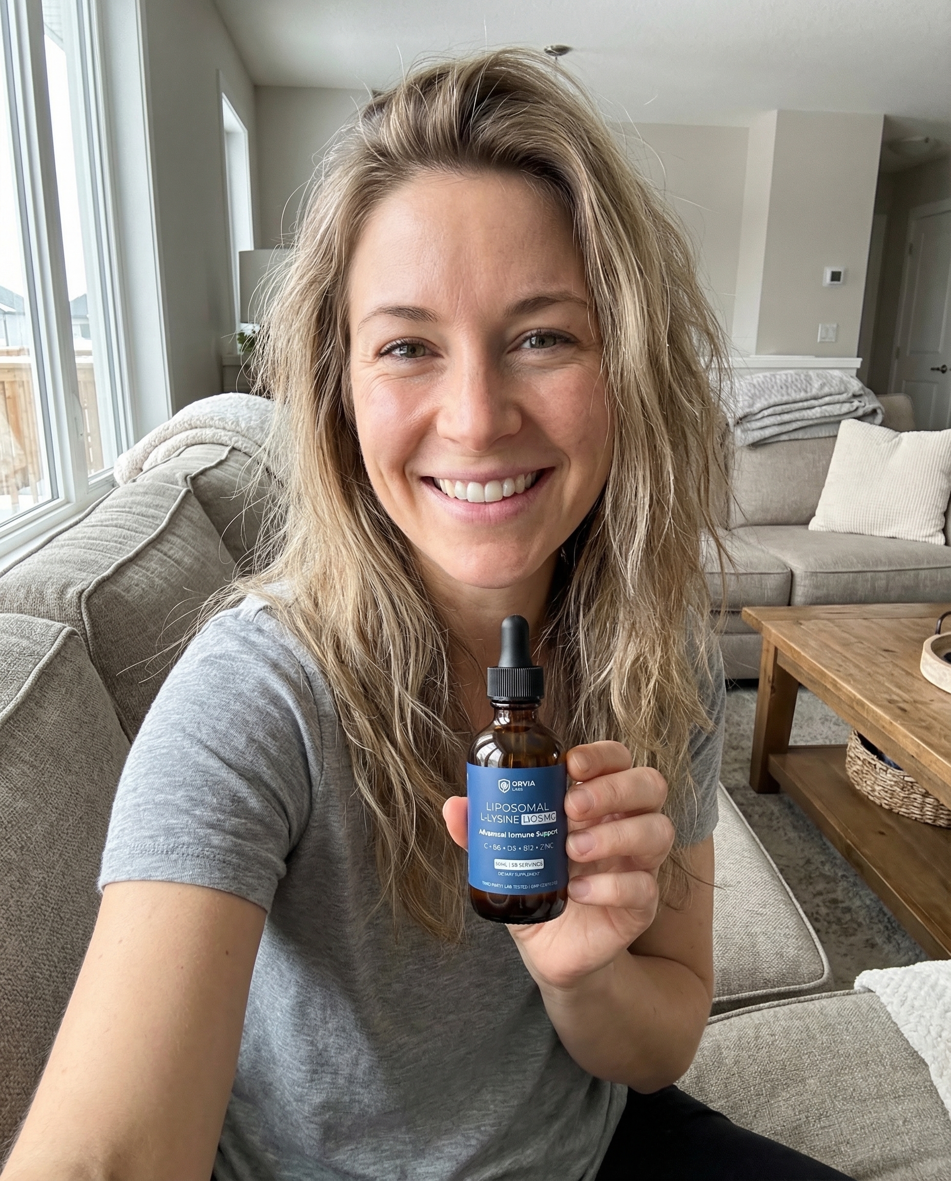 Kate holding the Orvia Labs bottle in her kitchen, smiling